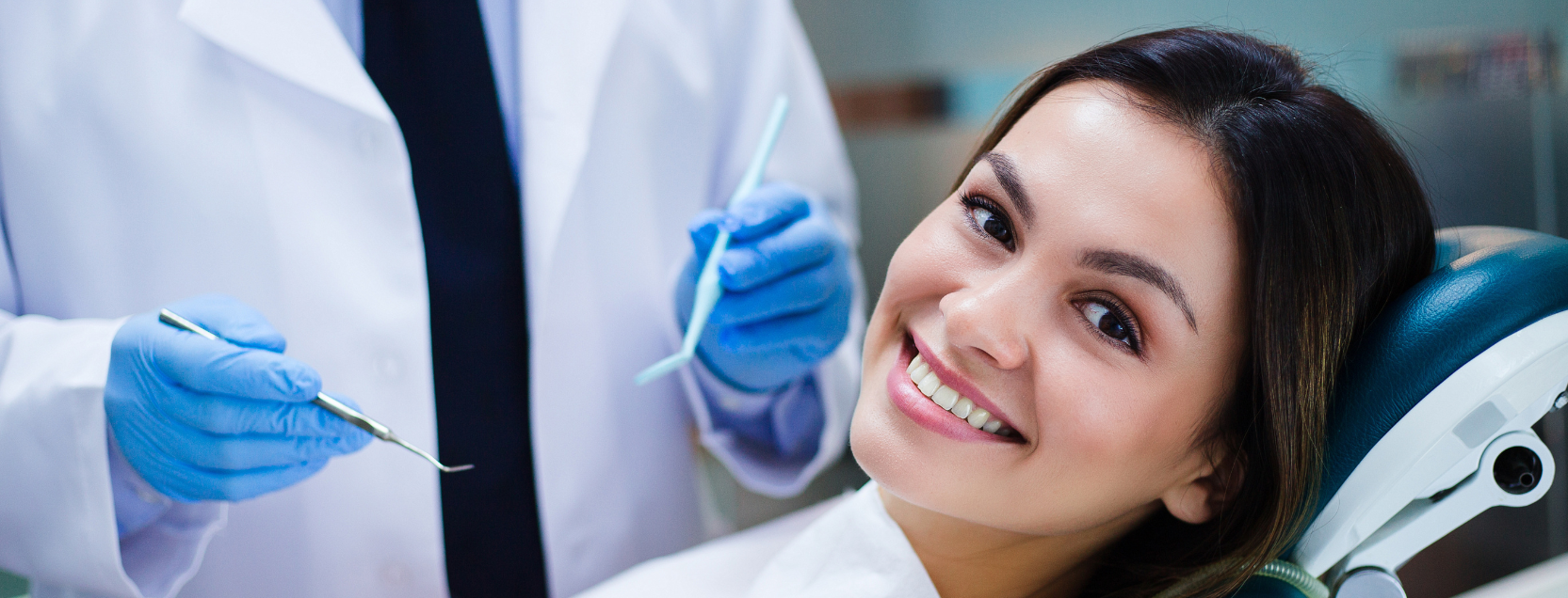 woman smiling in a dentist chair